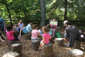children listen to a story outdoors